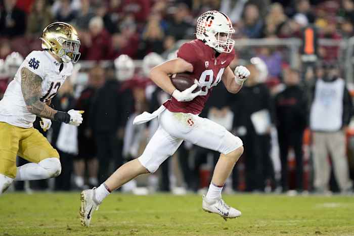 Nov 27, 2021; Stanford, California, USA; Stanford Cardinal tight end Benjamin Yurosek (84) runs after a catch while being pursued by Notre Dame Fighting Irish defensive lineman Jordan Botelho (12) during the fourth quarter at Stanford Stadium. Mandatory Credit: Darren Yamashita-USA TODAY Sports